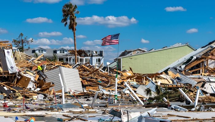 Buildings destroyed by hurricane and U.S. Flag still standing